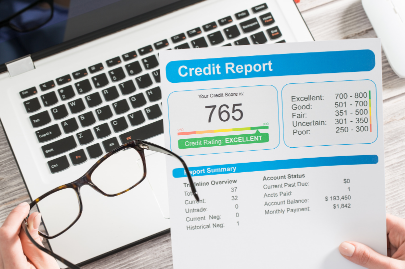 Credit Report in front of laptop